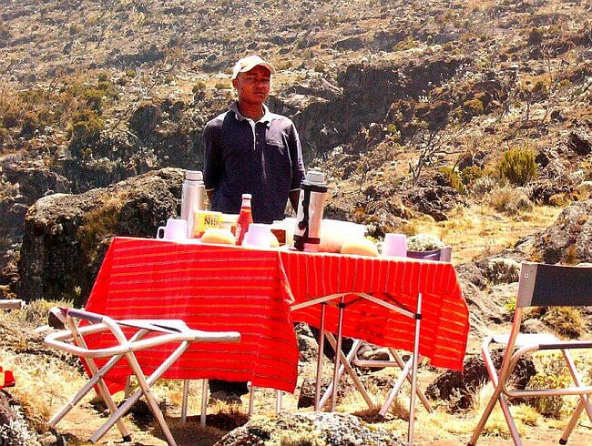 Godlove, the Assistant Guide, supervising lunch preparation.